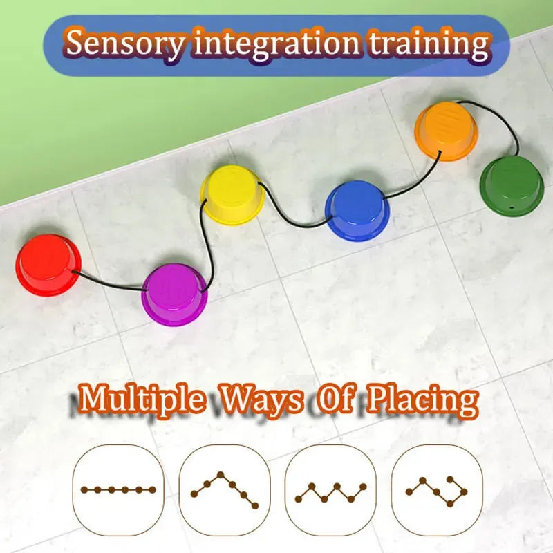 Montessori Colorful Balance Stones, linked by a black rope, are set on a tiled floor for sensory play. The text reads Sensory integration training and Multiple Ways of Placing, with diagrams illustrating various setups to boost developmental play.