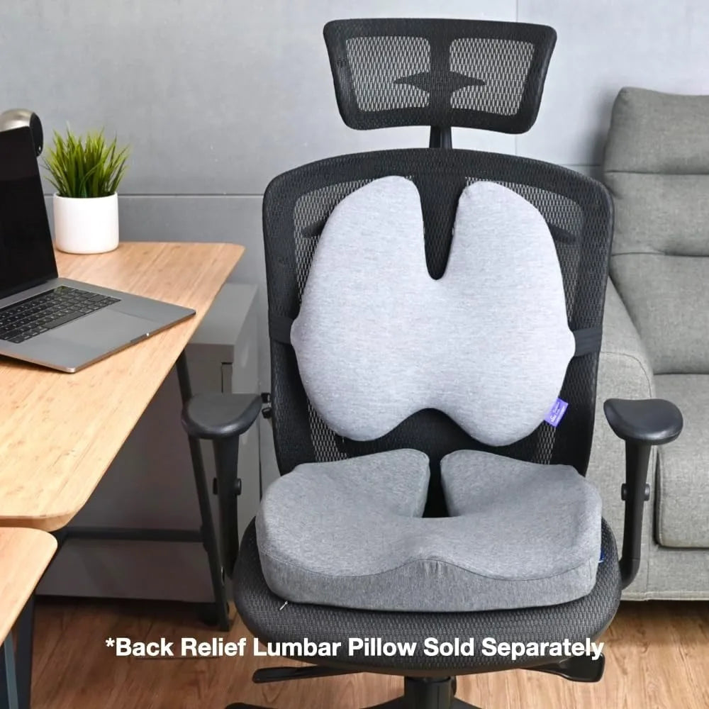 A black ergonomic office chair with a gray seat and memory foam backrest is shown next to a desk with a laptop. A gray sofa is visible nearby. Text mentions, Cushion Lab Patented Pressure Relief Seat Cushion for Long Sitting Hours Sold Separately.