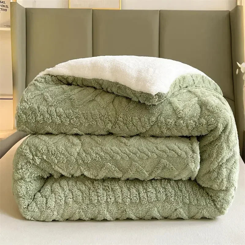 The Luxurious Artificial Cashmere Weighted Blanket for Ultimate Winter Comfort, soft and folded with a green exterior and white plush interior, rests on a light surface in front of an olive-green cushioned headboard, creating a cozy bedroom ambiance.