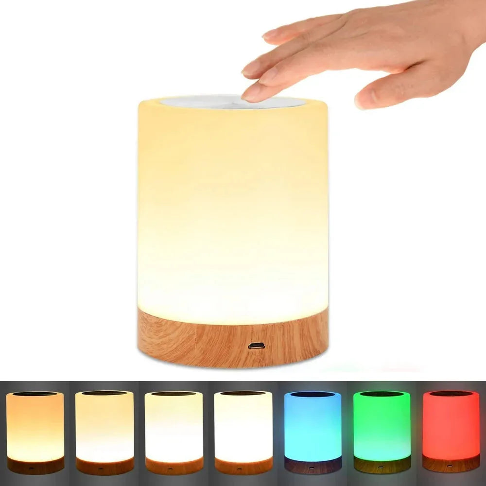 A hand reaches to a rechargeable cylindrical LED night light with a wooden base, casting warm light. Below are images showing the Portable Touch-Sensitive LED Night Light in various colors: yellow, orange, blue, green, and red.
.