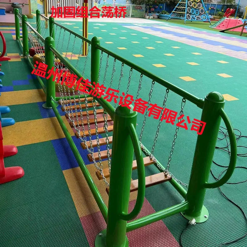 A vibrant playground features a green frame rope bridge for kids aged 3-8, with wooden planks and metal chains. The ground is covered in colorful interlocking mats, and the image includes red Chinese text. Part of the outdoor toys Childrens swings Climbing nets product line. Unisex design.