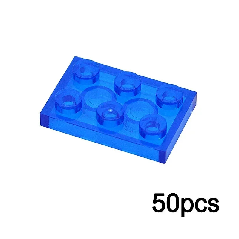 A 2x3 transparent blue building block from the MOC Transparent Bulk Brick Set, fully compatible with Lego, shown at an angle. 50pcs at the bottom right indicates this clear wall/house part set.