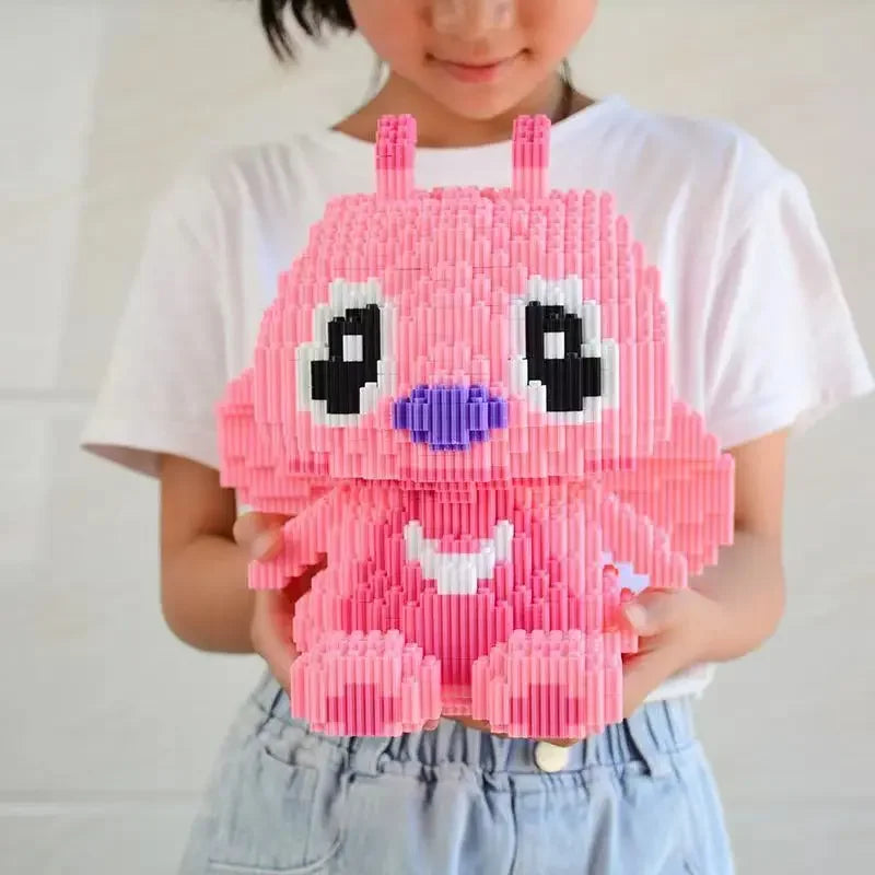 A child in a white shirt holds the Large Stitch Building Block Assembly Toy, a 30cm 3D puzzle featuring big eyes, a purple nose, and a smiling mouth—an interlocking plastic brick toy for kids and birthday gifts.