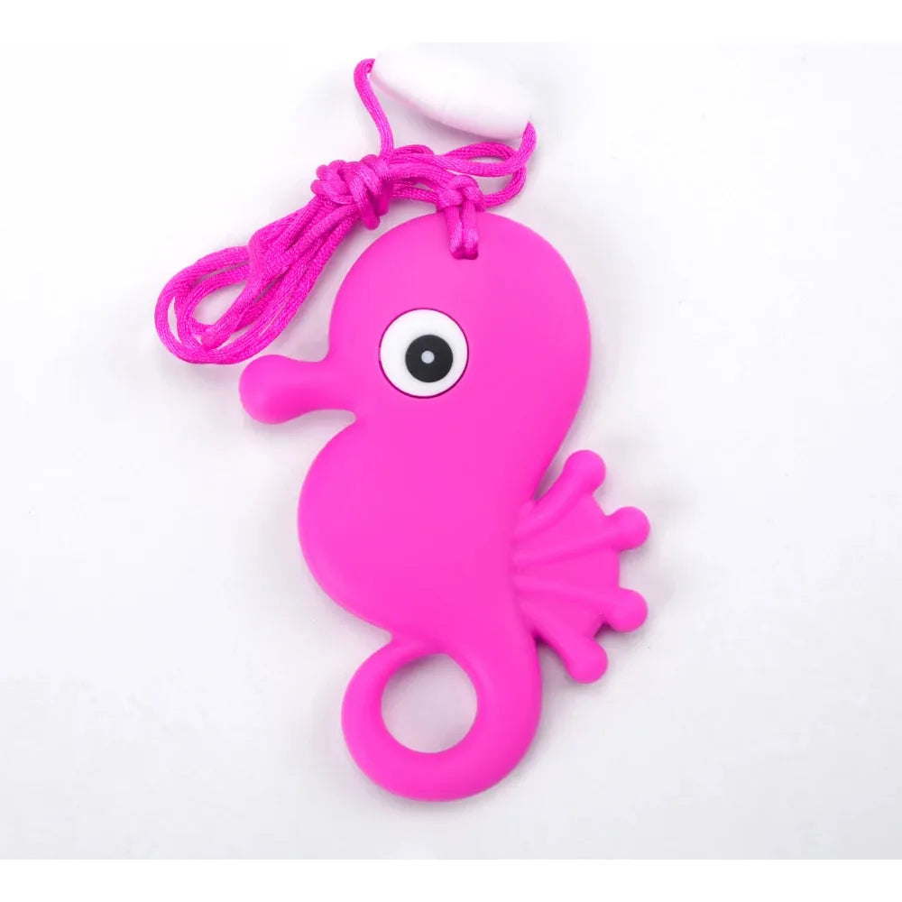 The Silicone Chewable Necklace for Kids is a pink rubber seahorse-shaped sensory teether pendant with a large eye, small fin, and loop. Attached to a pink cord, its ideal for oral motor therapy and doubles as a chew necklace for kids with autism or ADHD.