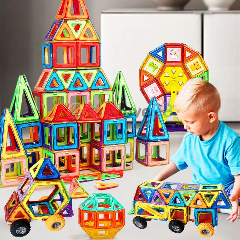 A child in a blue shirt enjoys STEM learning with the Giant Magnetic Building Blocks Set, creating a large castle and a geometric vehicle with wheels, while other safe and durable structures are visible nearby.