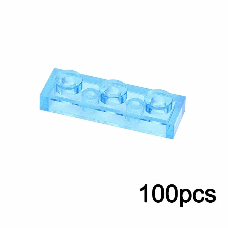 A 1x3 TRN light blue MOC Transparent Bulk Brick Set building block, compatible with Lego, is shown on a white background with 100pcs in the lower right corner.