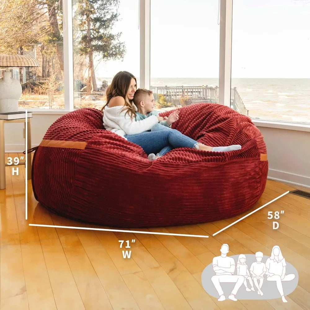 A woman and child sit on a Fuf XXL Foam Filled Bean Bag Chair Deep Terracotta 6 Feet in a sunlit room overlooking water. Measuring 39H x 71W x 58D, this bean bag fits four people.