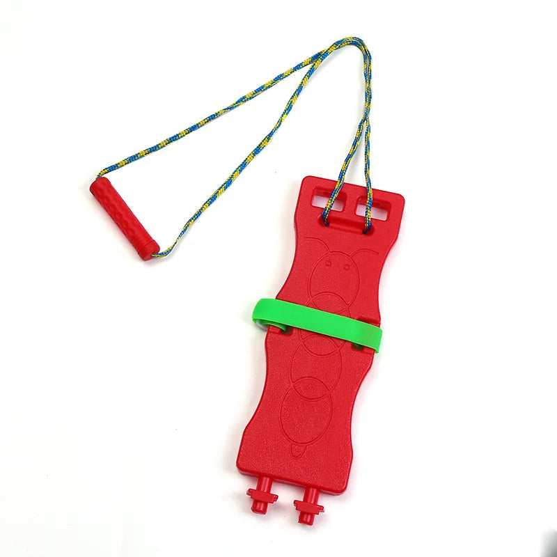 The Interactive Outdoor Balance Board Seesaw for Kids is a red plastic ski exerciser with a green band, dual footrests, a blue and yellow braided rope, and red handle. It doubles as an outdoor toy to enhance sensory training and balance while providing active fun.