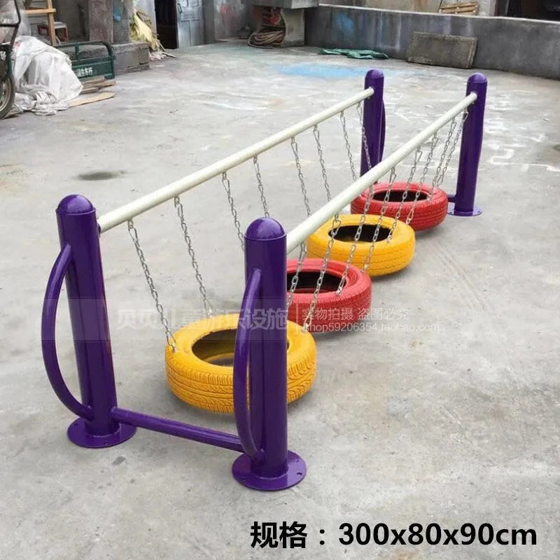 The Outdoor Steel Climbing Frame Swing for Childrens Sensory Integration features vibrant red, yellow, and orange hanging tire swings. Supported by purple posts with a white top rail, its dimensions are 300x80x90 cm.