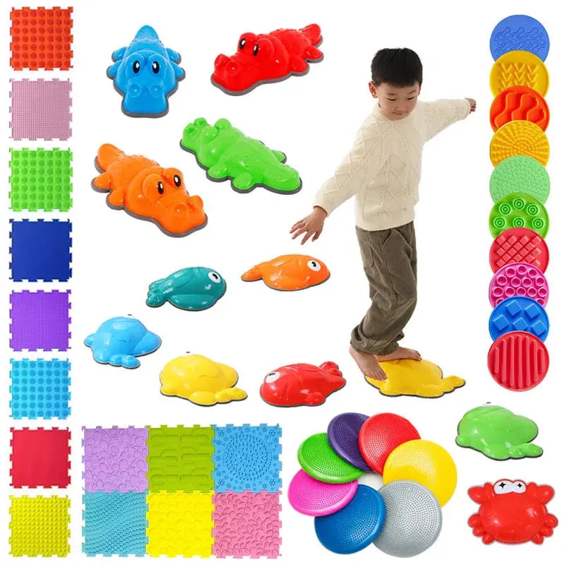 A child in a white sweater practices balance on colorful animal-shaped stepping stones, surrounded by Montessori Sensory Integration Foot Toys for Kids, including fish shapes, round discs, and foam puzzle mats with vibrant colors and patterns for enhanced sensory integration.