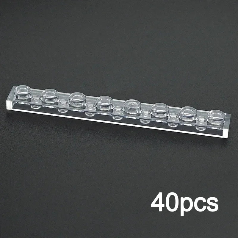 A clear, rectangular 1x8 transparent MOC Bulk Brick, compatible with Lego, is shown on a dark surface. 40pcs in white appears at the bottom right—ideal for expanding your building block collection.