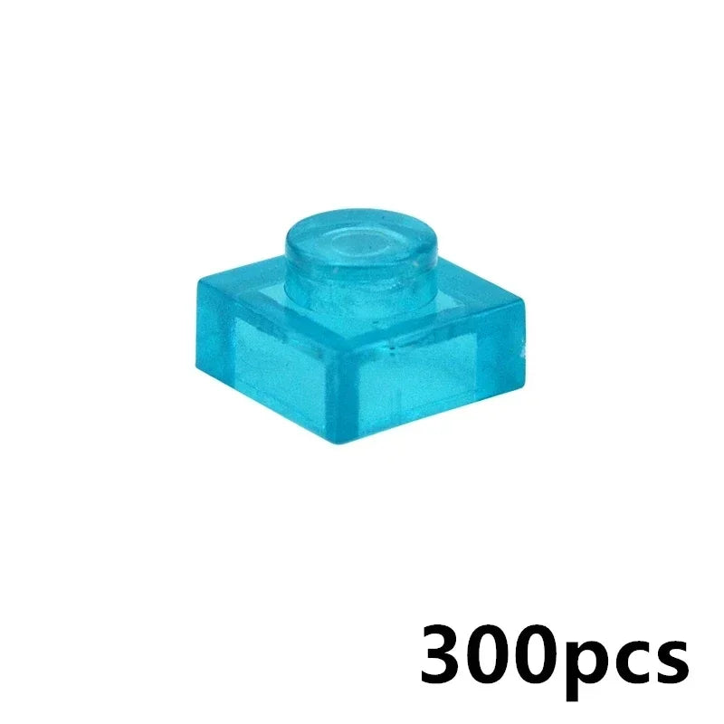 A 1x1 transparent blue MOC brick, compatible with LEGO, is displayed on a white background. 300pcs appears in black at the bottom right—ideal for building block collections or creative wall panel designs.