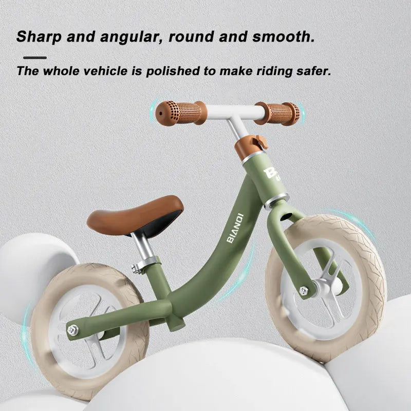 The Magnesium Alloy Toddler Balance Bike, featuring green and white colors with brown grips and seat, is showcased on a white surface with large round shapes. This 12-inch bike for kids aged 3-12 highlights polished features for style and safety.