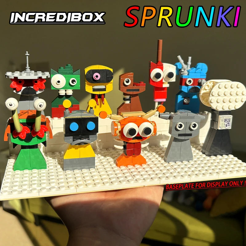 A hand holds a baseplate with ten colorful, unique LEGO characters from the New Moc Incredibox Sprunki Building Blocks Set (411pcs). INCREDIBOX and SPRUNKI are at the top; BASEPLATE FOR DISPLAY ONLY appears at the bottom.