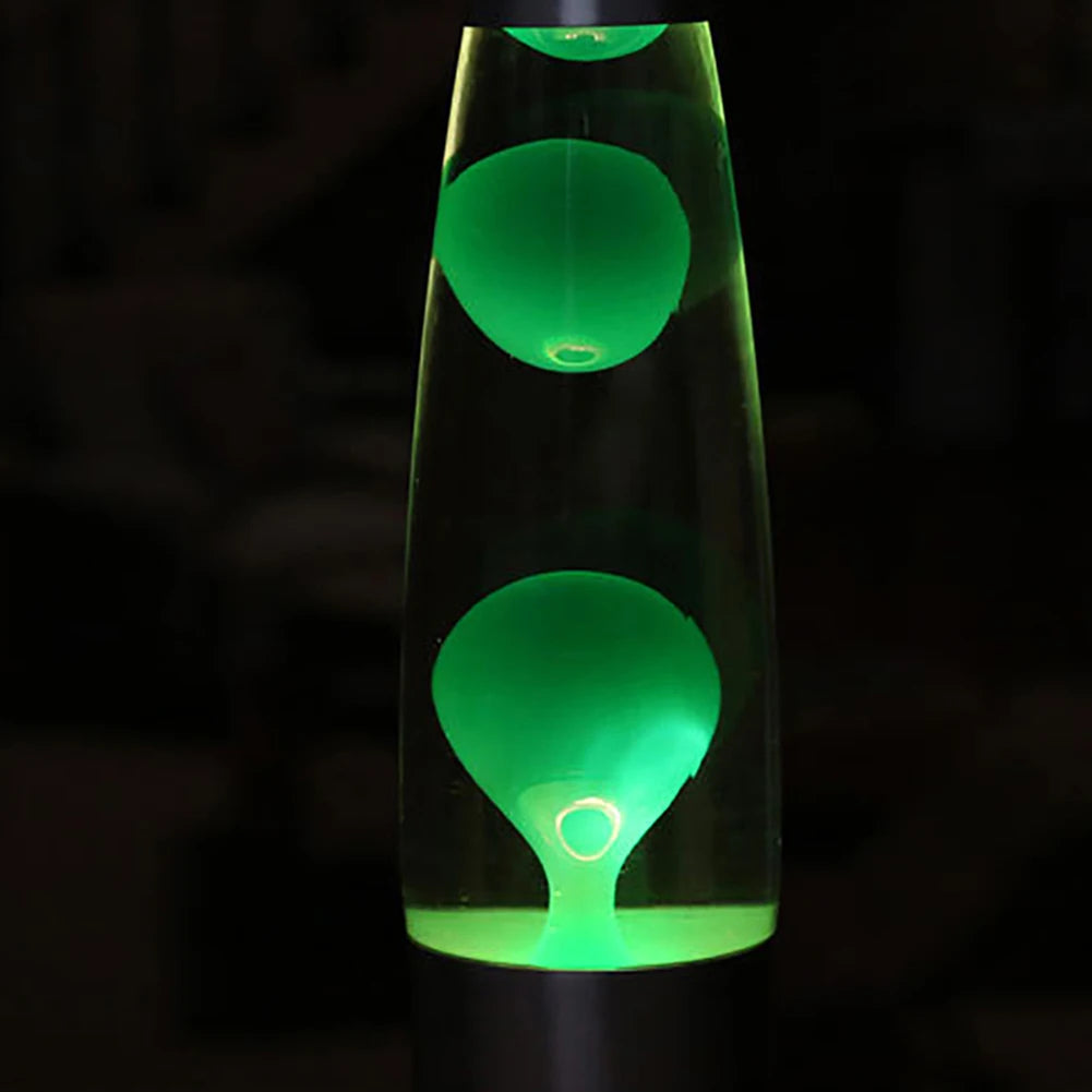 The Luminous Volcano Lava Jellyfish LED Night Light, a creative 25W atmosphere lamp, features glowing green liquid bubbles in a glass container. Set against a dark backdrop, it highlights vibrant colors and creates an ambient feel, perfect for retro-inspired home decor.