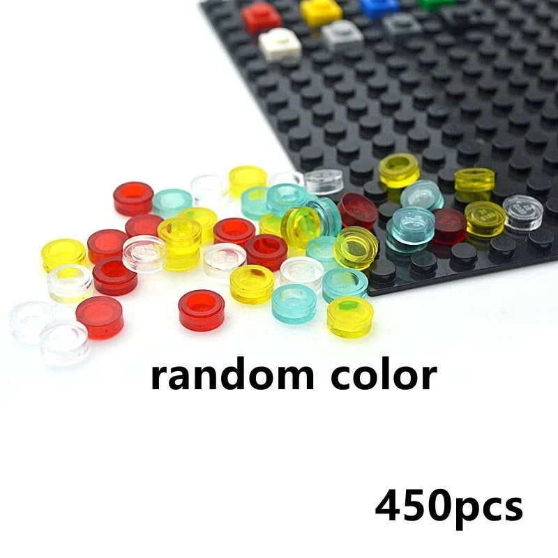 A pile of small, round, translucent MOC Transparent Bulk Brick Set (1x1, 1x2, 1x4, 2x4) in random colors lies on a black base plate. Compatible with Lego, includes 450pcs for building walls or houses.