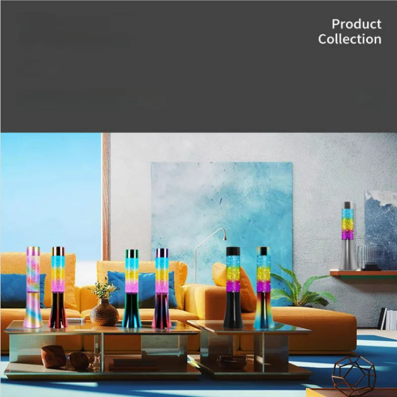 A modern room features 13-inch LED color-changing glitter lava lamps on glass tables. The space highlights a light blue sofa, textured blue wall art, and beige decor. On the right is a low bookshelf with decor. Text reads Product Collection.