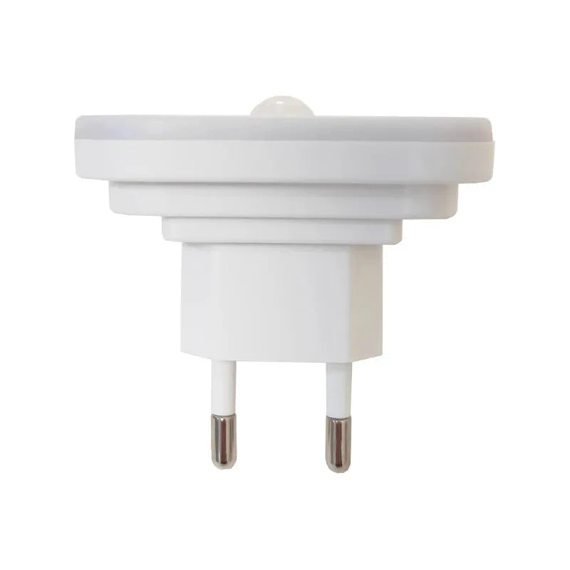 The Dimmable Motion Sensor LED Night Light with EU Plug boasts a rounded rectangular design, ideal for indoor use in a babys room, bedroom, or corridor. With two prongs for outlets and a discrete front sensor detecting light levels, it blends seamlessly into any space while offering wireless lighting.