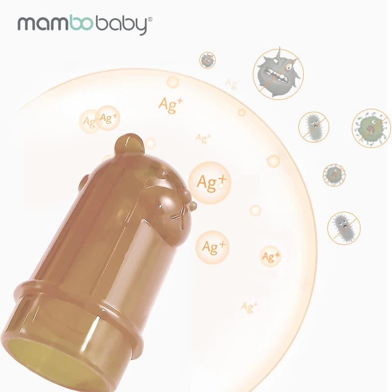 A brown bear-shaped toothbrush cover floats among bubbles with Ag+ symbols and cartoon germs. Ideal for kids kicking thumb-sucking, the mambobaby logo appears top left on a white background.