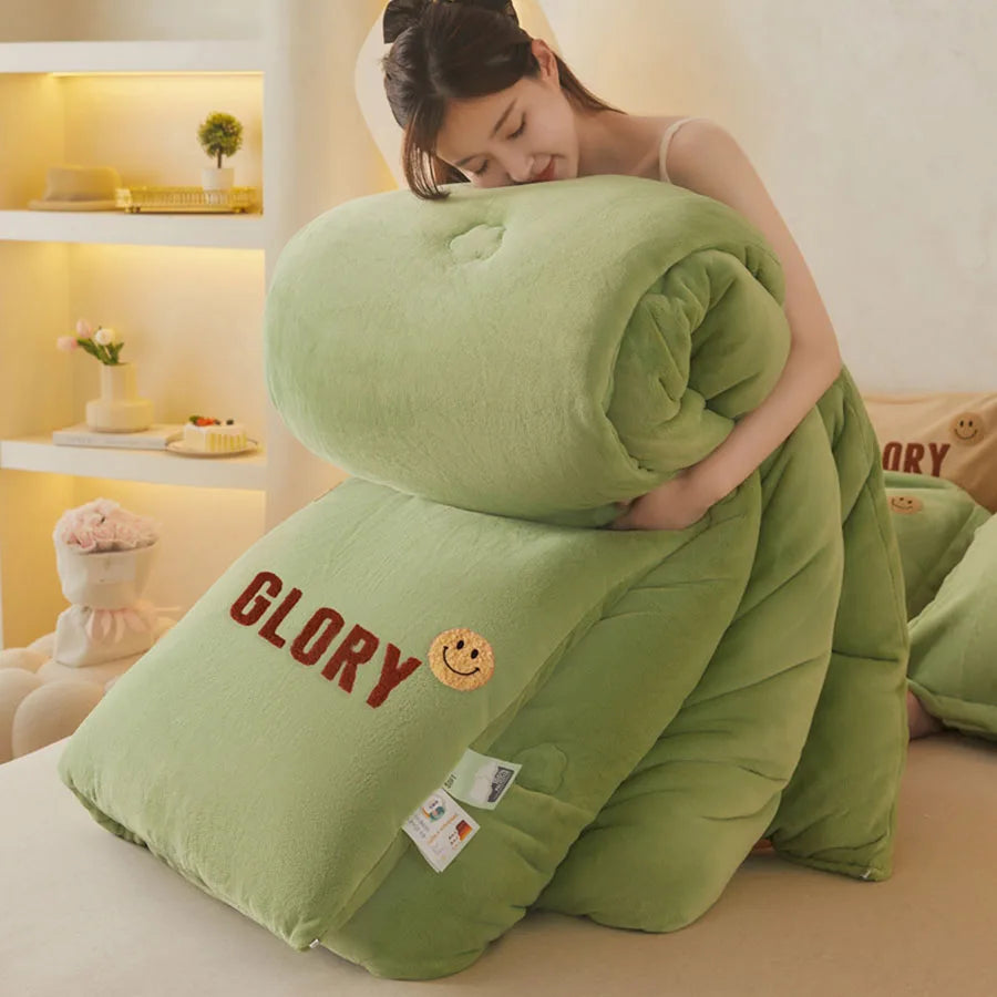 A person is hugging the KDJEIKZ Ultra Cozy Winter Weighted Blanket, embroidered with GLORY and a smiley face. This thick comforter features a milk velvet texture, adding warmth to the cozy room surrounded by a shelf and cushions in the background.