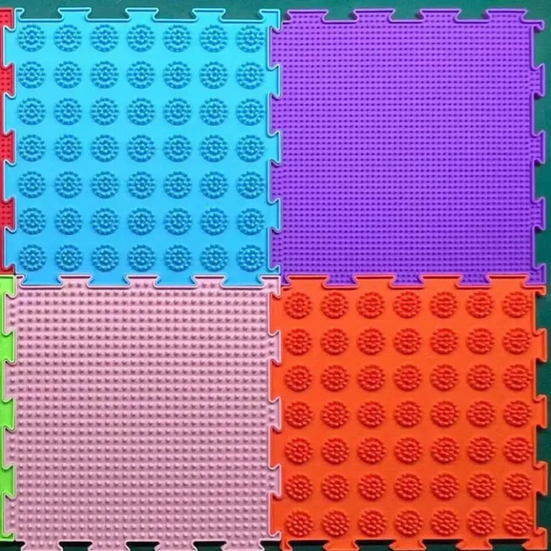 Vibrant Montessori Sensory Integration Balance Stones feature interlocking blue, purple, pink, orange, and red textured foam mats with raised patterns like circles and dots for sensory stimulation. Ideal sensory toys or colorful additions to Montessori educational setups.