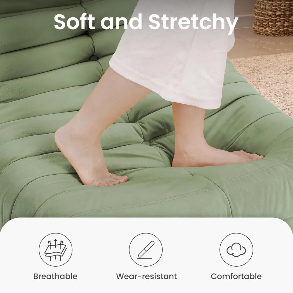 Bare feet step on the soft, green Fireside Chair Bean Bag for adults—crafted with cozy suede fabric. Above, text says “Soft and Stretchy.” Icons below show its breathable, wear-resistant, and comfortable features.