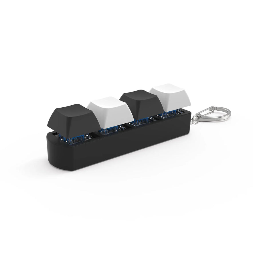 The 4Keys Finger Button Anti Stress Toy is a black-and-white keychain featuring four mechanical keyboard keycaps in a row on a black base, ideal for office decompression and quick stress relief for kids and adults.