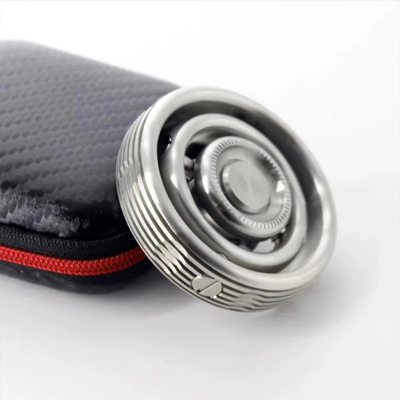 The Stainless Steel Fidget EDC Gyroscope Spinner, a stress relief toy for adults, features intricate designs and rests on a black textured case with a red zipper against a white background, blending fidget elements perfectly.