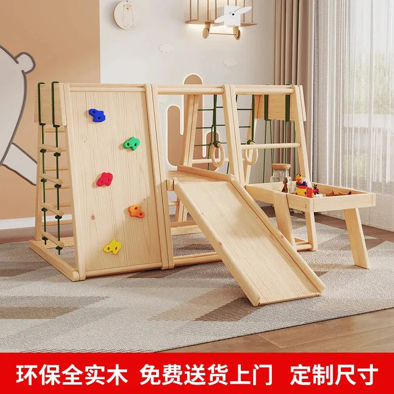 The Indoor Wooden Climbing Frame for Kids with Slide and Swing is a sensory play set promoting development and fun. It features a climbing wall, slide, chalkboard, colorful holds, and an attached table with a chair, perfect for placement on a wooden floor in a well-lit room with windows.