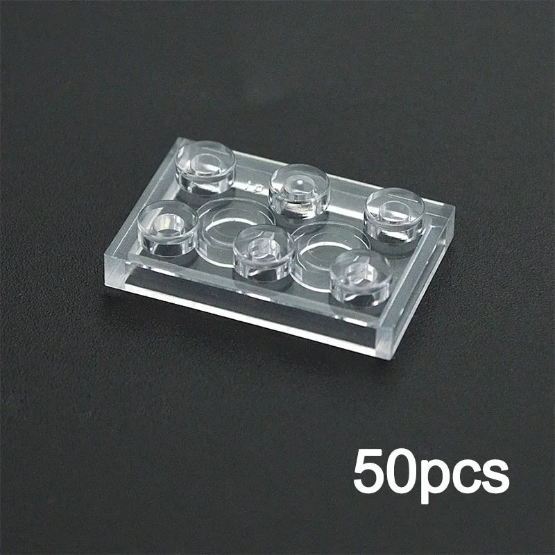 A 2x3 transparent MOC bulk brick, compatible with Lego, is shown on a black surface. The text 50pcs in white appears in the bottom right—ideal for expanding your clear building block collection or custom wall and house designs.