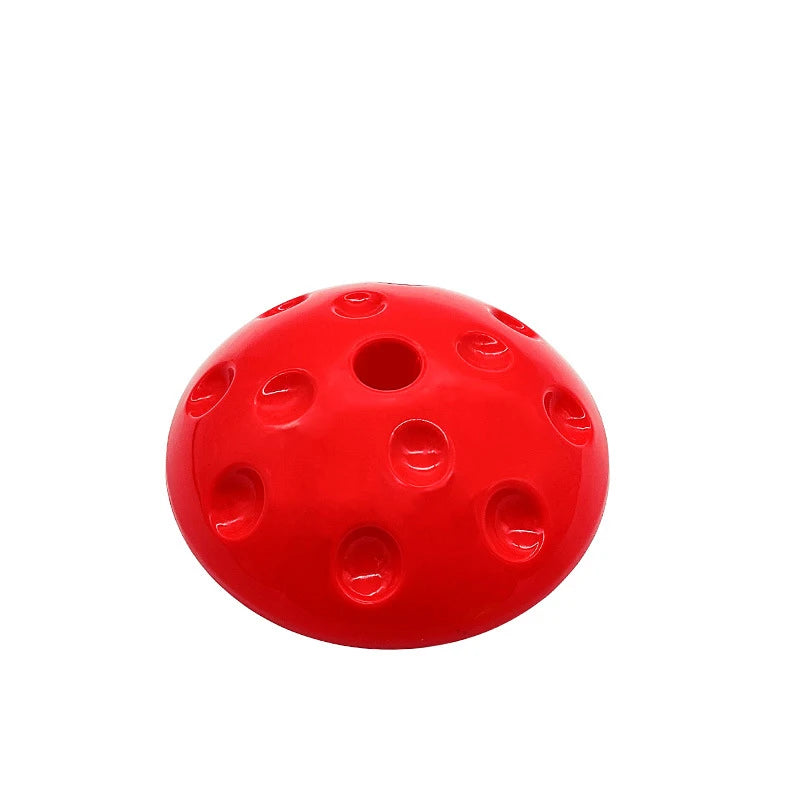 A red, dome-shaped object with a smooth surface and circular indentations is designed for motor skill enhancement. Its center hole forms a symmetric pattern, ideal for sensory integration activities like Montessori-Inspired Kids Balance Stepping Stones for Sensory Play and Social Skills Development.