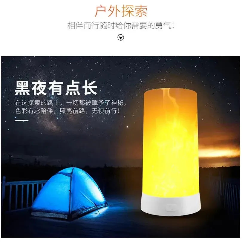 A glowing Simulated Flame LED Night Light and a blue camping tent sit on a wooden deck under a starry sky. The lamps realistic flame simulation brings warmth to the scene, with Chinese text above and nearby.
