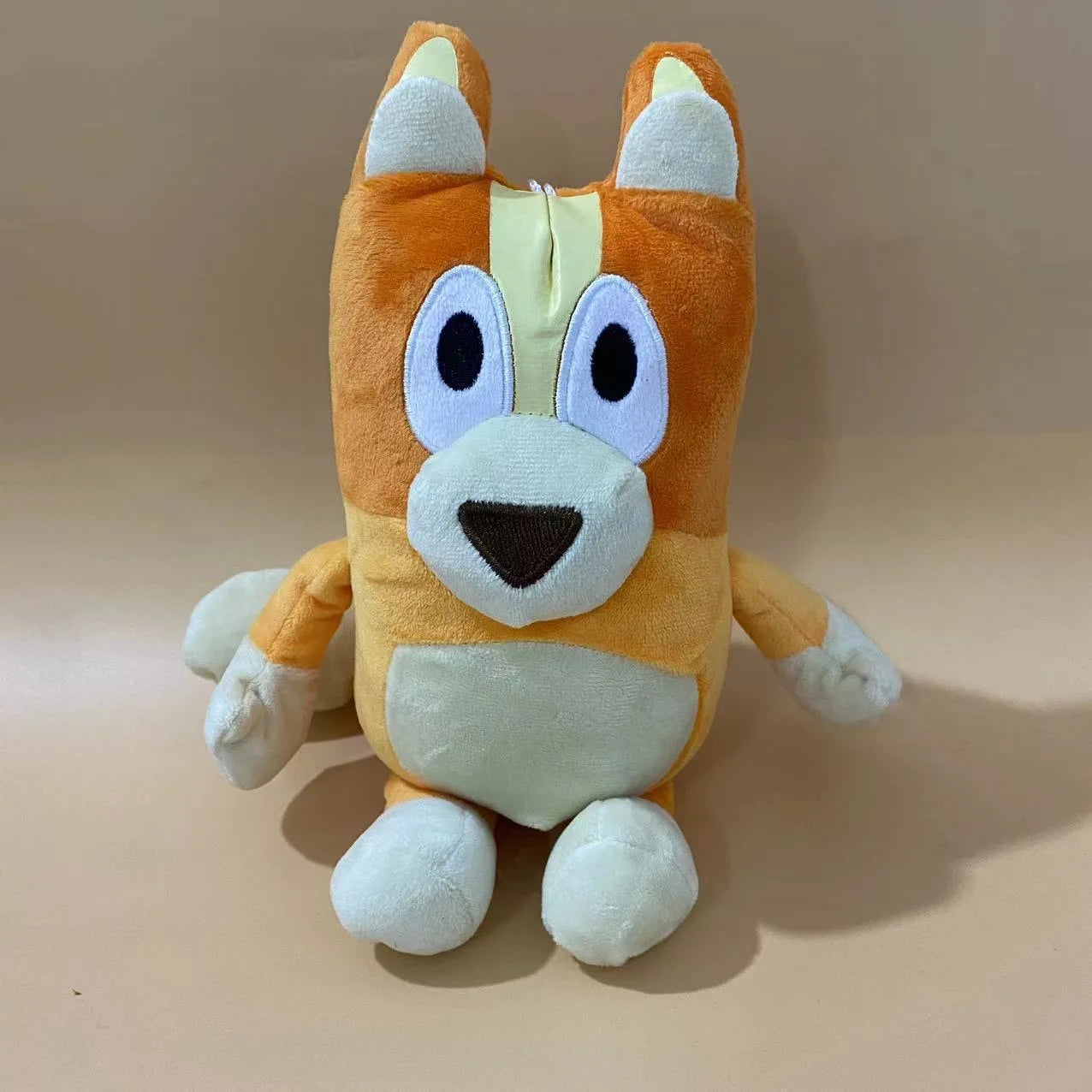 A 17cm, 28cm, or 40cm Bluey and Bingo Family Plush Toy in the “younger sister” color sits on a tan background—an adorable cartoon dog stuffed doll, perfect for birthday or Christmas gifts and fans of plush toys.