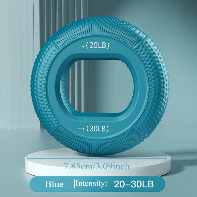 Introducing the Silicone Grip Trainer Ring for Hand Strengthening and Wrist Rehabilitation, a blue textured grip ring that improves grip strength with 20-30 lb resistance. Designed with a 7.85 cm diameter, it is displayed on a white platform against a light blue background.