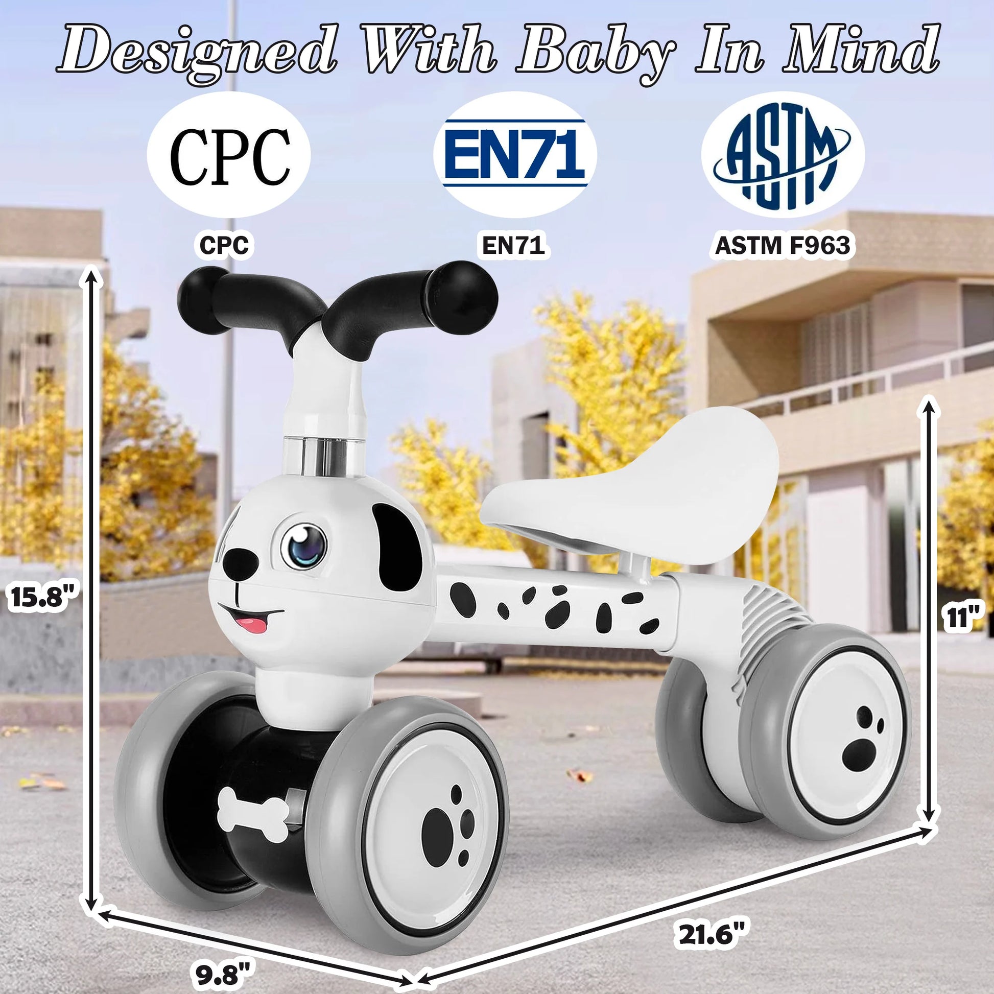 A Baby Balance Bike With 4 Wheels for toddlers ages 12 to 36 months is shown outdoors in a white and black dalmatian theme. Measures 15.8 tall, 21.6 long, and 9.8 wide with an 11 seat height—perfect first birthday gift!.