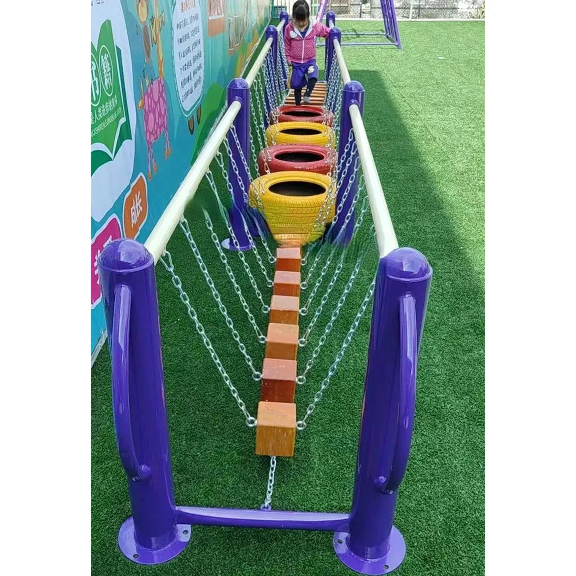 A child aged 3-8 joyfully explores a colorful playground obstacle course with chains and wooden steps, vibrant purple posts, and multi-colored tires on grass. This unisex area also includes outdoor toys like climbing nets and swinging bridges for engaging sensory integration sports fun.