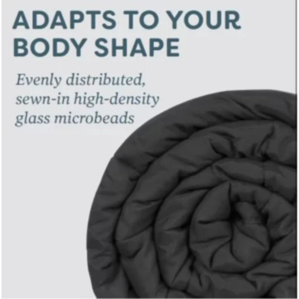 A rolled-up dark gray Plush 20lb Soft Weighted Blanket showcases its expert material blend with Adapts to your body shape and Evenly distributed, sewn-in high-density glass microbeads. Origin US craftsmanship ensures comfort and quality in every stitch.