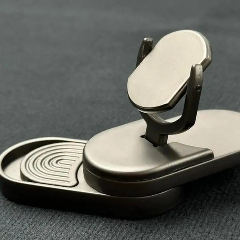 A close-up of the Fidget Slider Magnetic Metal Spinner Toy—a portable, metallic sensory spinner with a foldable design and oval holder, ideal for adults at home, travel, or school. Features a rubber grip for added stability.
