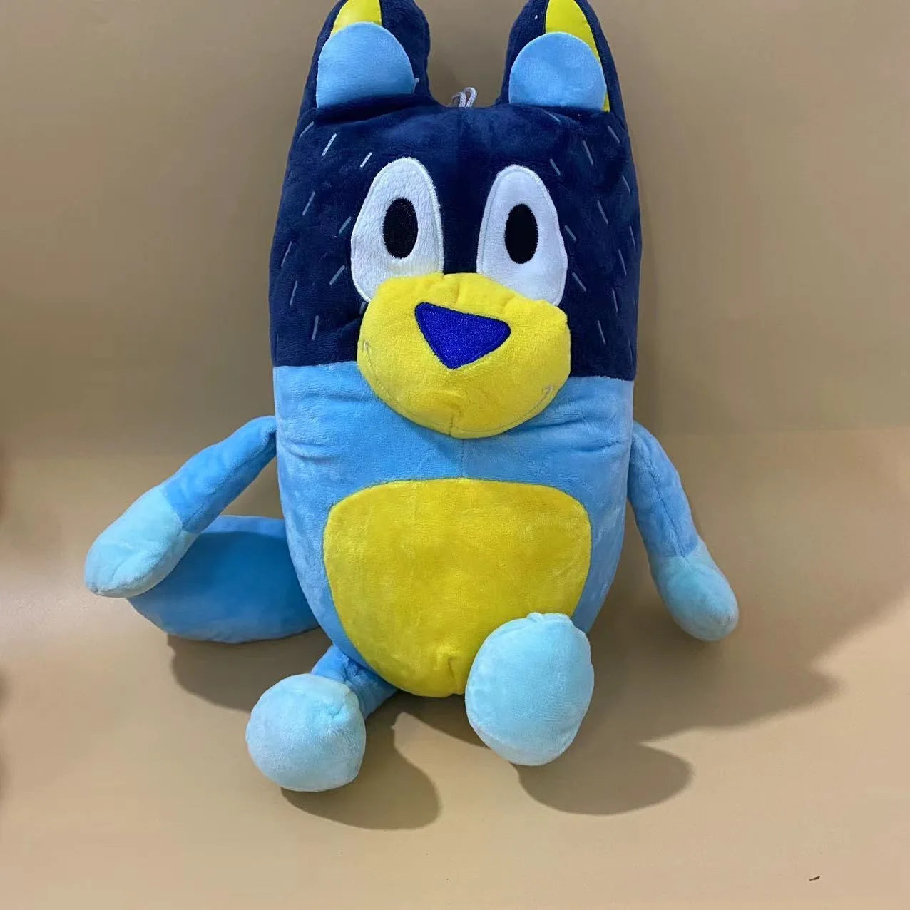 The 17cm, 28cm, and 40cm Bluey and Bingo Family Plush Toys (dad color) are soft cartoon dog stuffed dolls—perfect birthday or Christmas gifts for fans of plush animals. Photographed sitting against a plain beige background.