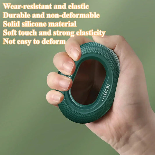 A hand squeezes a green Silicone Grip Trainer Ring for Hand Strengthening and Wrist Rehabilitation, highlighting its wear-resistant and elastic qualities. With a soft touch and strong elasticity, it offers grip strength up to 40 pounds against a soothing green blurred background.