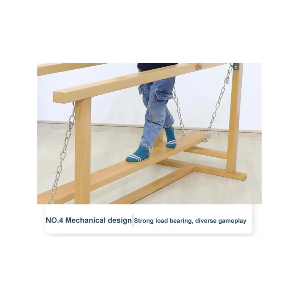 A child wearing blue striped socks and jeans walks on a suspended wooden plank bridge, akin to an indoor balance beam, connected by chains. Above the image, text reads: NO.4 Mechanical design | Strong load bearing, diverse gameplay. Product: Indoor Wooden Balance Beam Sensory Training Toy for Children 3-12 Years.