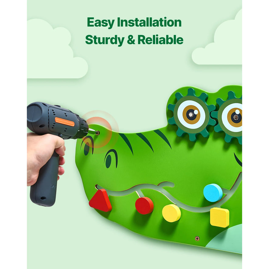A hand installs the Vevor 9 Activities Crocodile Kids Busy Hanging Board Toy, featuring gears and colorful shapes for fine motor development. Text above reads, “Easy Installation Sturdy & Reliable.”.