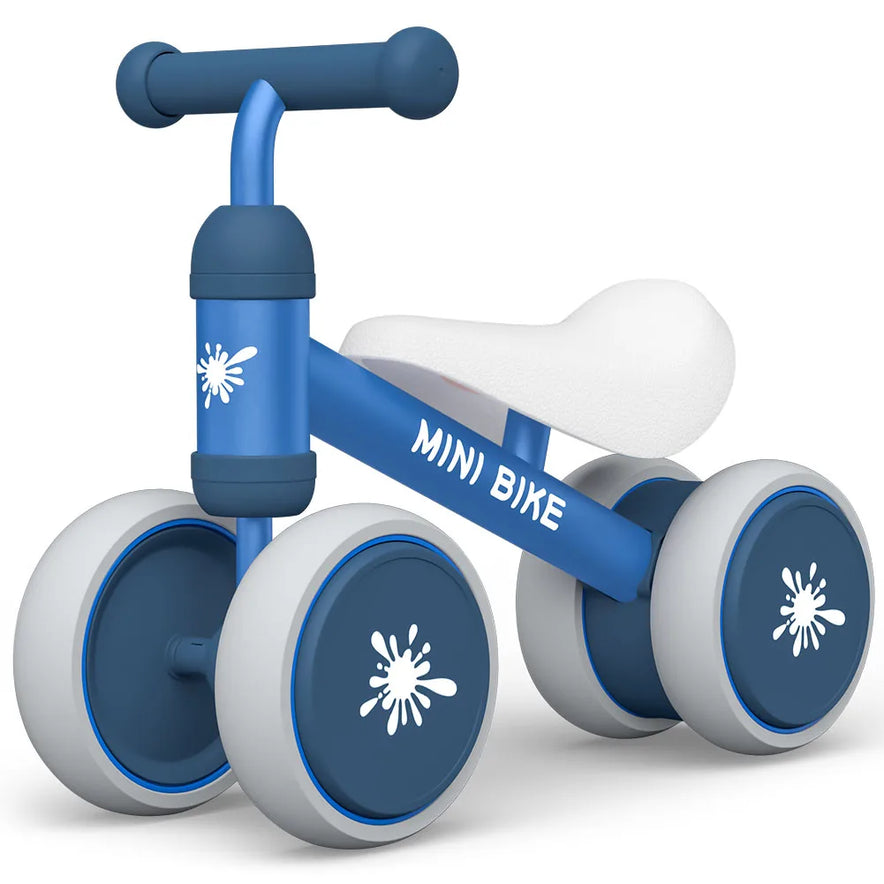 A small purple Baby Balance Bike Ride On Toy for 1 year old boys and girls with four thick wheels, cushioned white seat, and MINI BIKE on the side—ideal as a first birthday gift to support motor skill development.