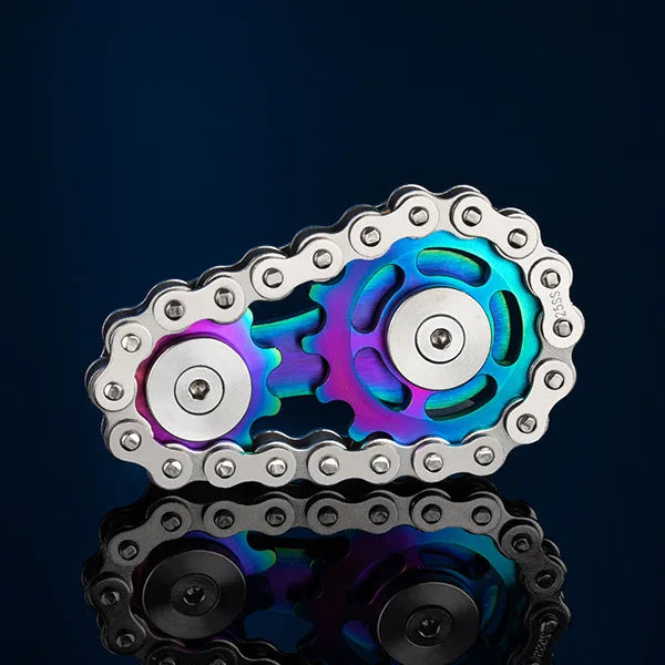 The Bike Chain Metal Fidget Spinner with Magnetic Slider, featuring silver chains and colorful sprockets, offers stress relief and an eye-catching look against a dark background, making it a perfect calming tool for adults and fun gift idea.