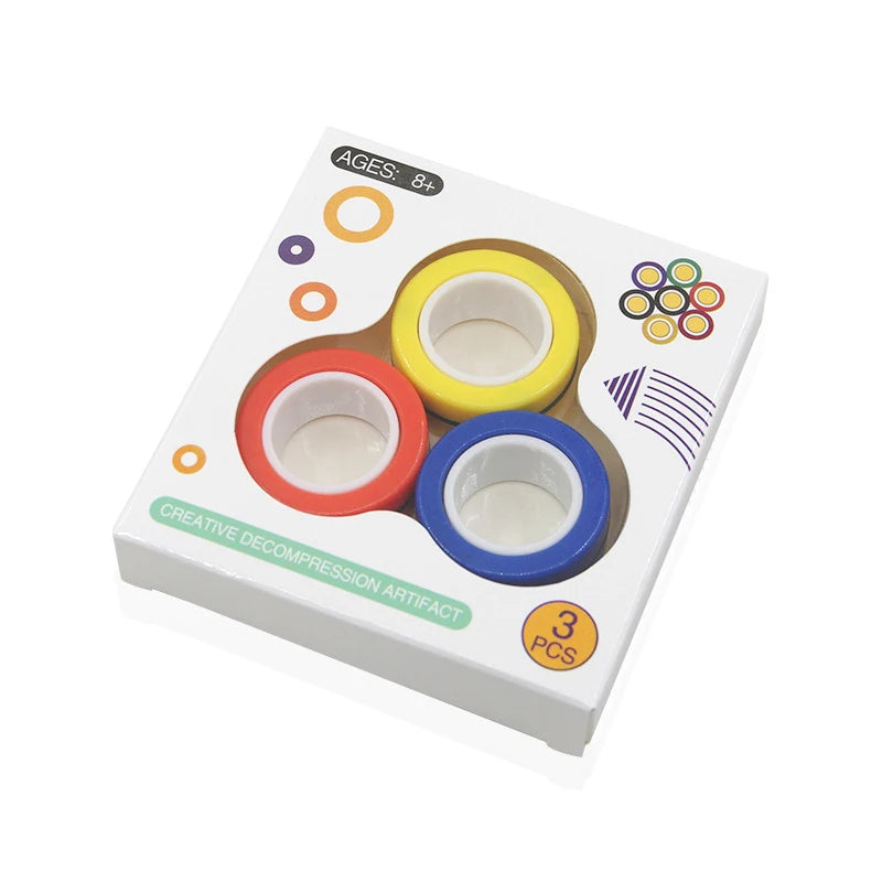 The 3PCS Finger Magnetic Rings Fidget Toys for Anxiety, ADHD, and Stress Relief come in red, yellow, and blue. Playful circles decorate the white box labeled “AGES: 8+” and “CREATIVE DECOMPRESSION ARTIFACT 3 PCS”—a fun stress-relief gadget.