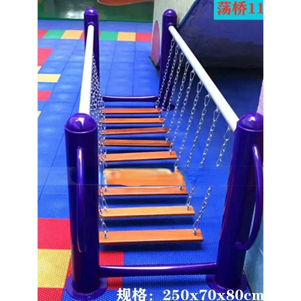The Outdoor Steel Climbing Frame Swing is ideal for sensory integration. It features blue-purple posts, orange plank steps, and silver chain links on a colorful foam mat with red, blue, and yellow squares. Text overlays display dimensions and additional information.