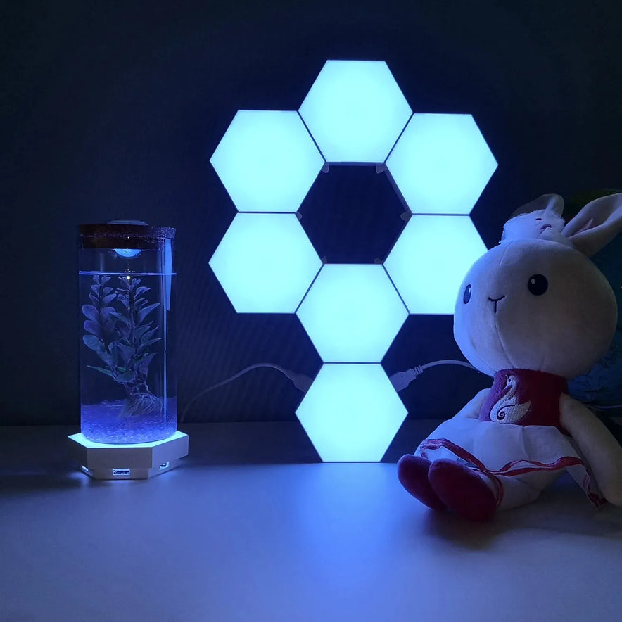 Hexagonal LED Modular Night Light Panels for Sensory Rooms, calming splicing geometry lamps for autism, glow and change color on a dark surface. Easily control the ambiance with the included remote control.