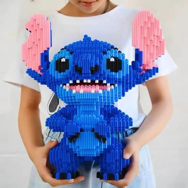 Someone holds the 30cm Large Stitch Building Block Assembly Toy, a detailed blue and pink 3D puzzle for children, perfect as a DIY birthday gift or desktop decoration.