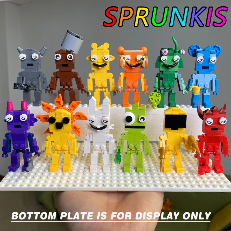 Twelve blocky robots from the New Moc Incredibox Sprunki Building Blocks Set (555pcs) stand on a white display plate. SPRUNKIS is at the top and BOTTOM PLATE IS FOR DISPLAY ONLY appears at the bottom. Great for birthdays and Christmas!.