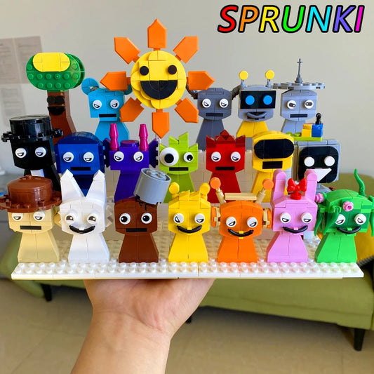 A hand holds the New Moc Incredibox Sprunki Building Blocks Set, featuring 20 colorful LEGO-style characters under SPRUNKI in rainbow letters, with a couch and chair in the background. Perfect horror anime music game gift!.